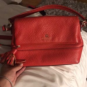 Red Kate Spade purse with short and longer handle